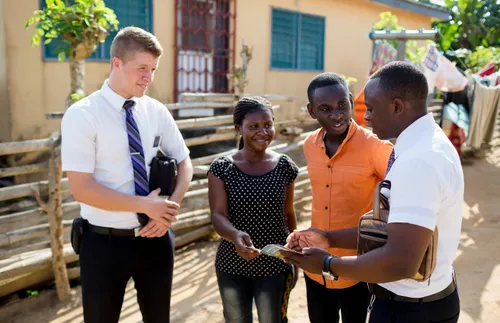 Photo of missionaries talking to a couple in a street