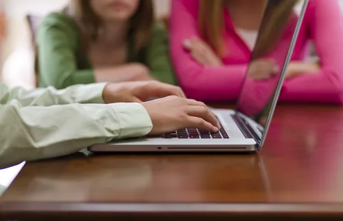 hands on laptop keyboard