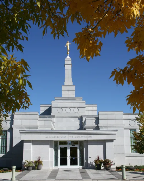 Doors of the Regina Saskatchewan Temple, with a view of the temple spire and a partial view of the trees on the temple grounds.
