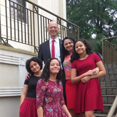 family standing on stairs