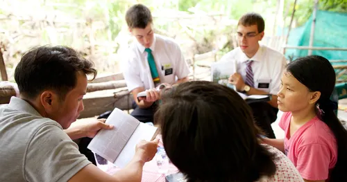 missionaries teaching a family