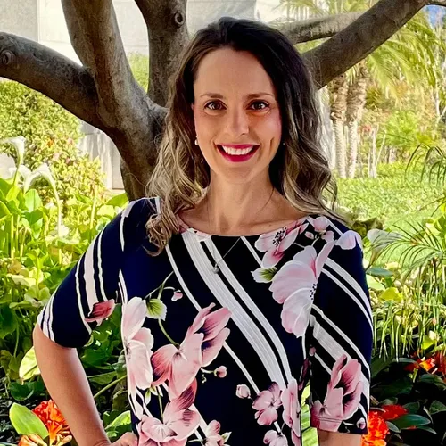 woman standing by a tree