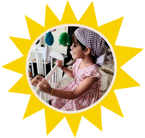 girl sining to baby sister