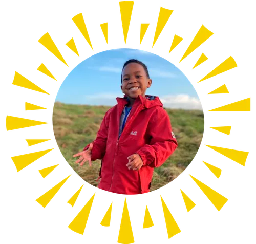 boy outside in red coat