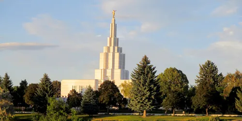 Exterior image of the Idaho Falls Idaho Temple with water in the foreground.