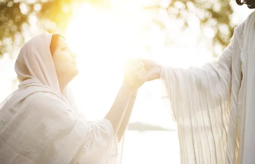 young woman holding the Savior’s hand