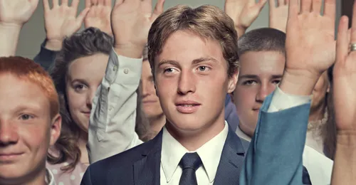 young man with other youth raising hands