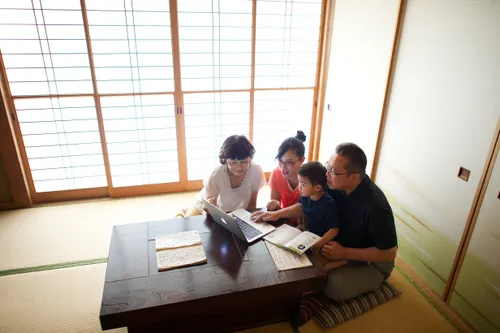 family gathered around a laptop computer