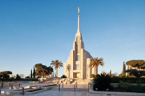 The Rome Italy Temple against a clear blue sky.
