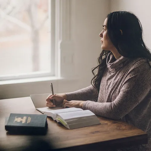 woman looking out a window