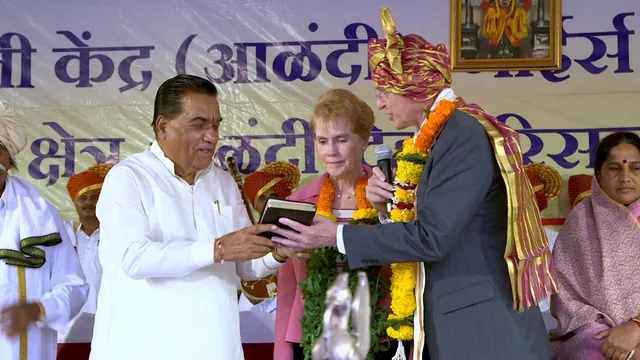 Elder D. Todd Christofferson of the Quorum of the Twelve Apostles, along with his wife, Sister Kathy Christofferson, presents a copy of the Book of Mormon to World Peace University President Dr. Vishwanath D. Karad in Pune, India, August 14, 2017.