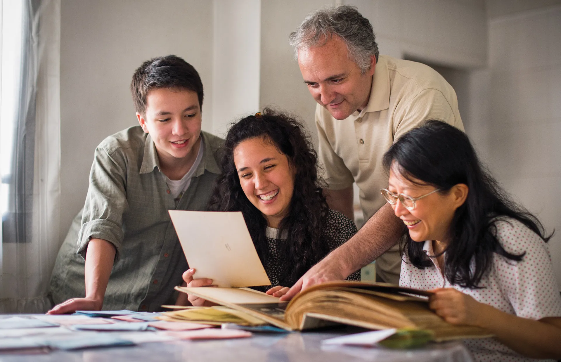 A family looks at old photos together.
