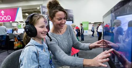 mother and daughter looking at monitor screen