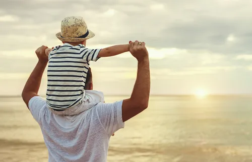 dad with son sitting on his shoulders