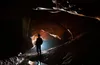 young man standing in a cave