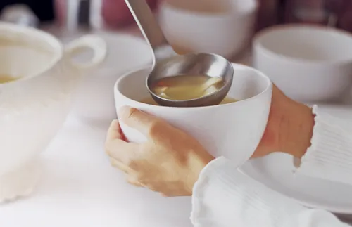 soup being ladled into a bowl