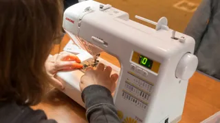 Woman sewing on sewing machine