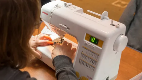 woman sewing on sewing machine
