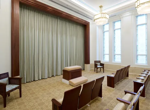 Interior image of the Bangkok Thailand Temple showing the Instruction Room. Image features an altar with chairs on two sides of the room.