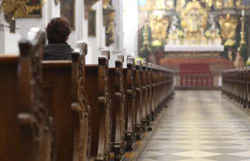 young adult man sitting in a pew
