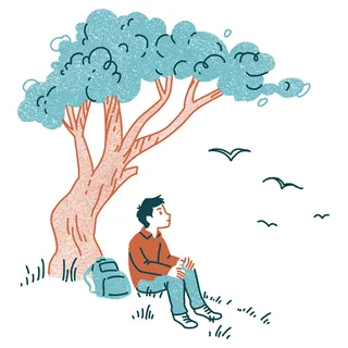 young man sitting under a tree