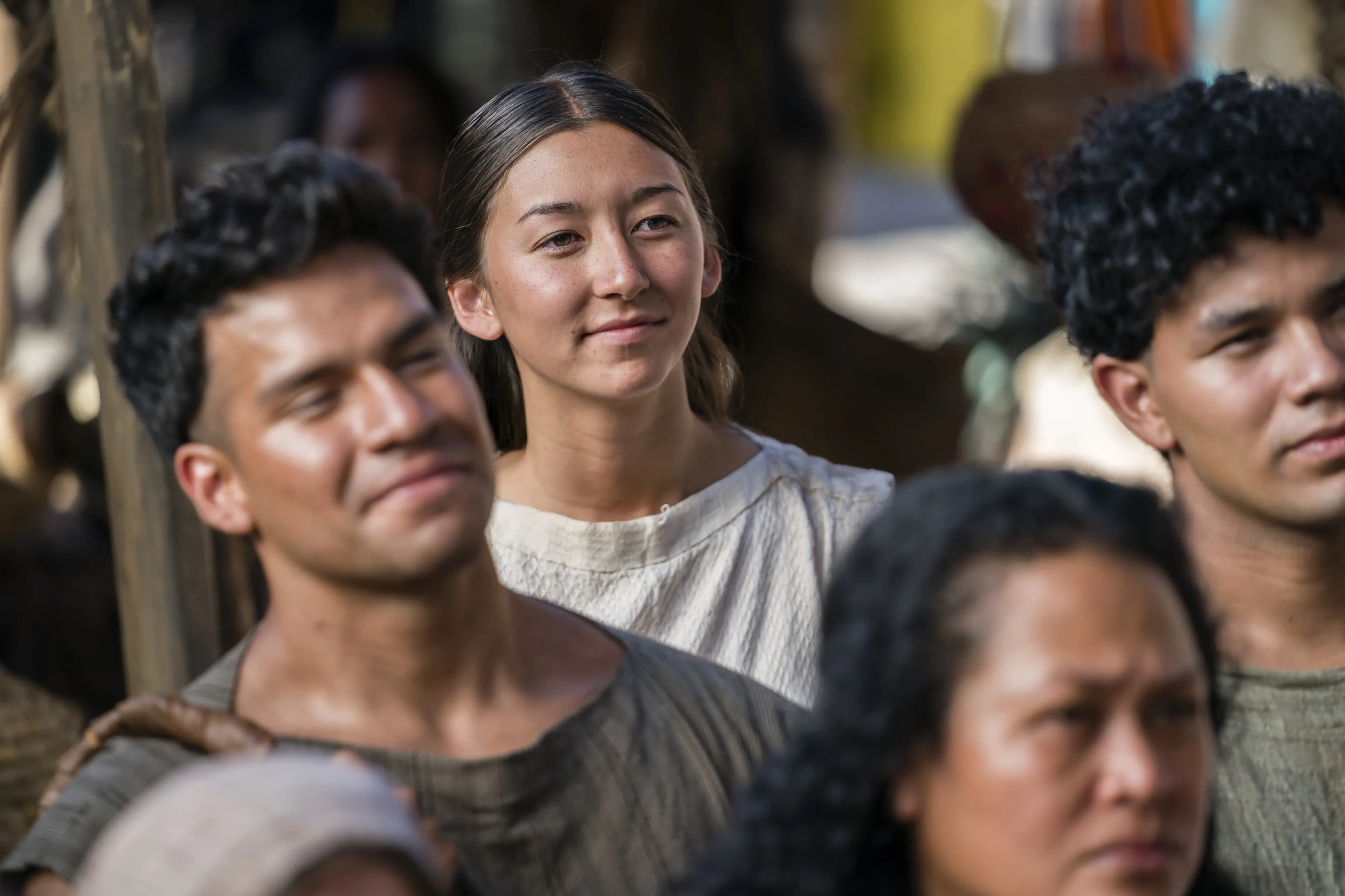 A young woman listens as Alma the Younger preaches to the people of Gideon.