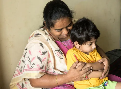 child praying with woman