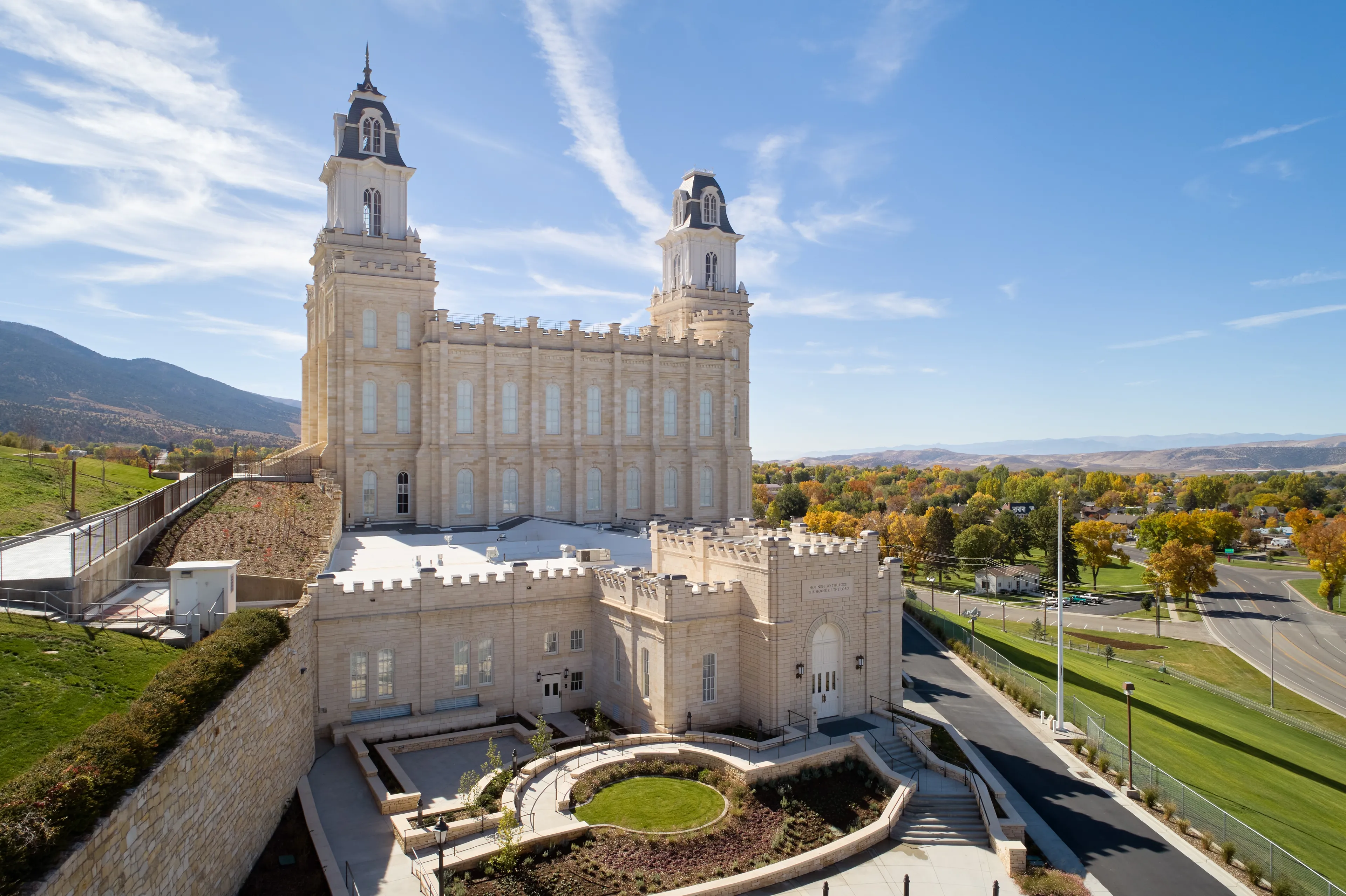 Exterior image of the Manti Utah Temple highlighting the temple itself and the surrounding temple grounds. The image is taken during the day.