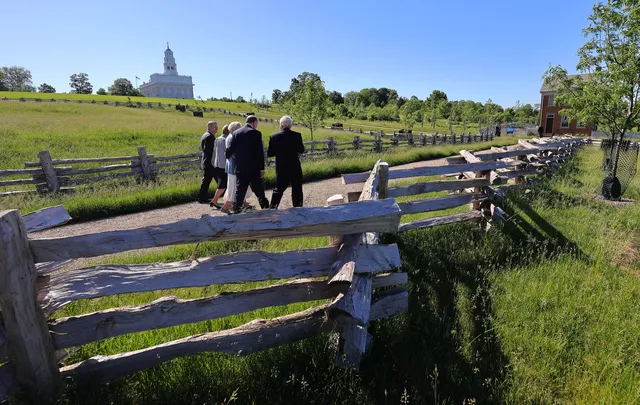 Elder Quentin L. Cook of the Quorum of the Twelve Apostles and his wife, Mary, walk with others through Historic Nauvoo on Saturday, May 29, 2021.