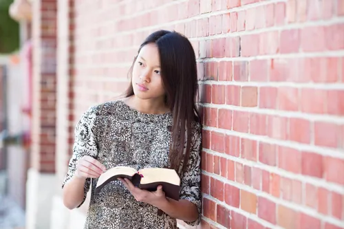 young adult woman reading scriptures