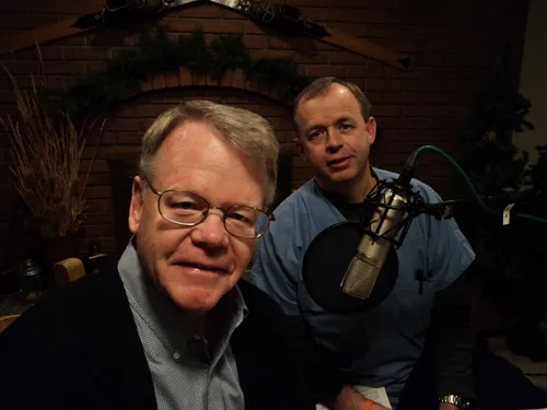 Two men beside a radio microphone.