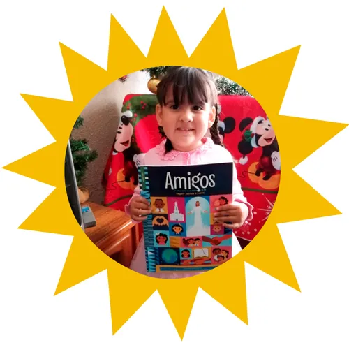 girl holding copy of the Friend in Spanish