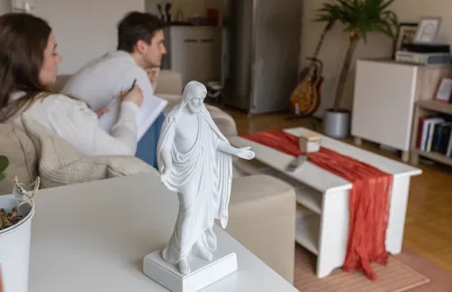 a small Christus statue next to some young adults