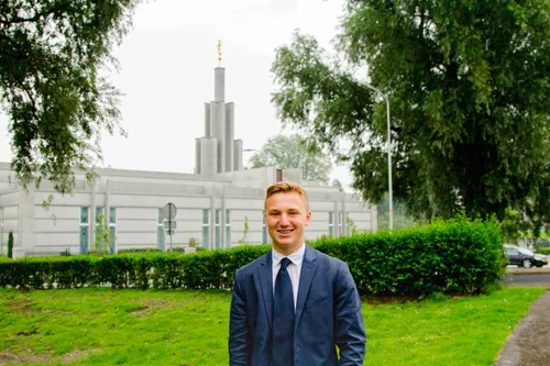 young man standing in front of temple