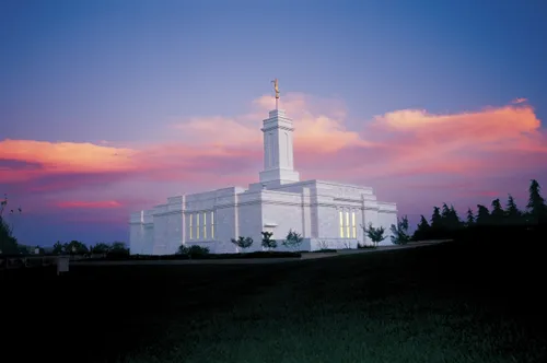 A view of the Colonia Juárez Chihuahua Mexico Temple at sunset, with pink clouds in a deep blue sky illuminating the background.
