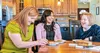 three women sitting at a table