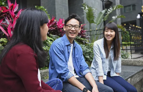 three young adults socializing