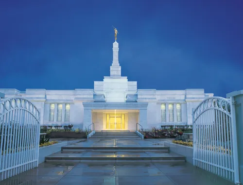 The front of the Oaxaca Mexico Temple in the evening, lit up from within.