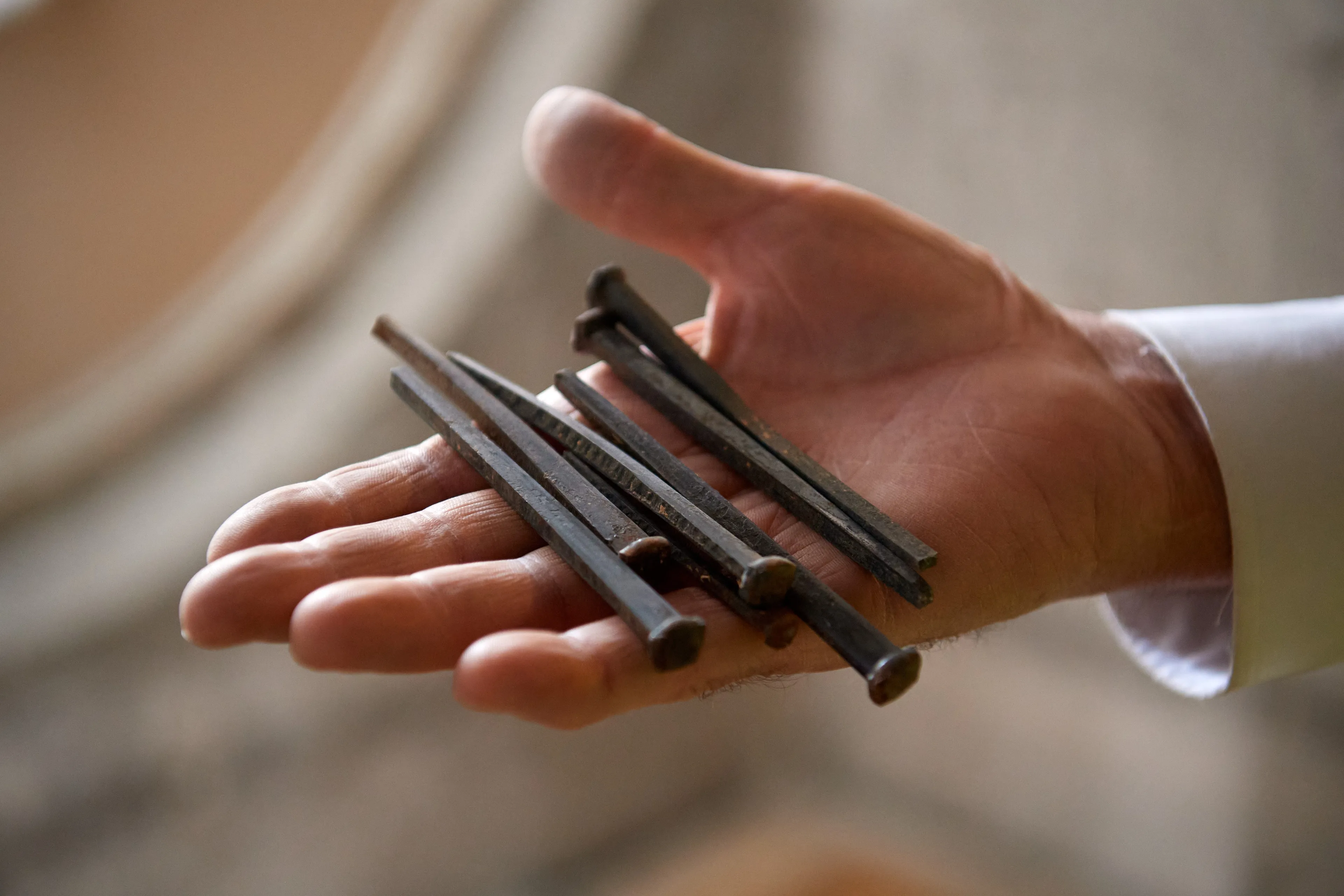 Construction on the Salt Lake Temple during September, 2020. A construction worker holds nails in their hands.  © undefined ipCode 1.