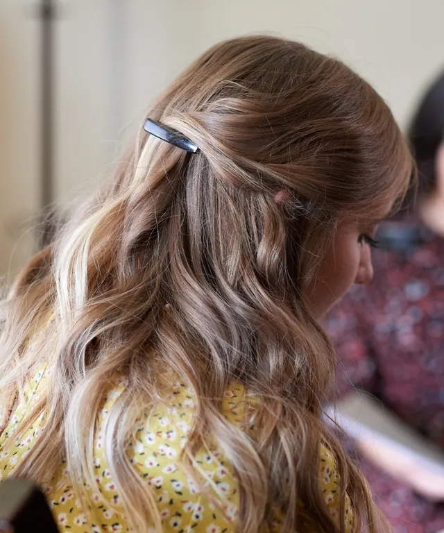 Two sister missionaries sit together. They study with one another. While studying they model appropriate dress standards.