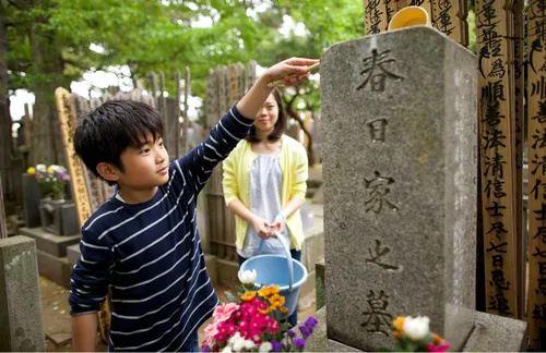 boy cleaning gravestone
