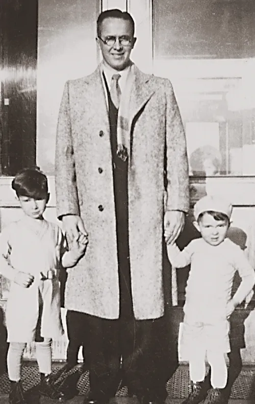 Ezra Taft Benson holding the hands of his two young sons, Mark and Reed.  taken in Boise, Idaho.