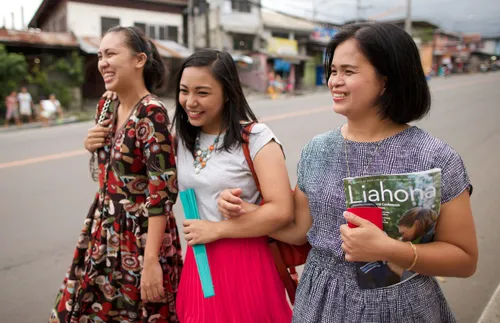 three women walking down the street