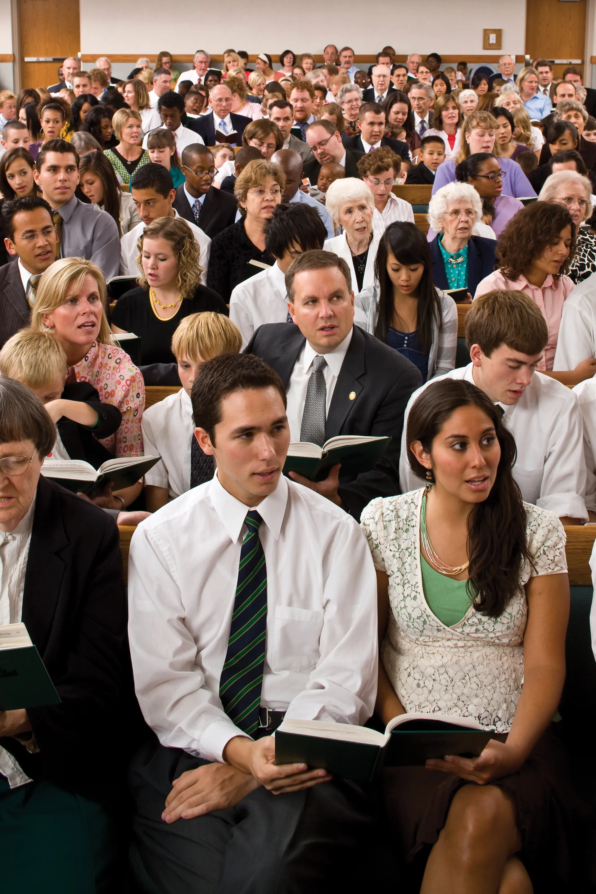 A congregation sitting in the chapel, singing a hymn together. © undefined ipCode 1.