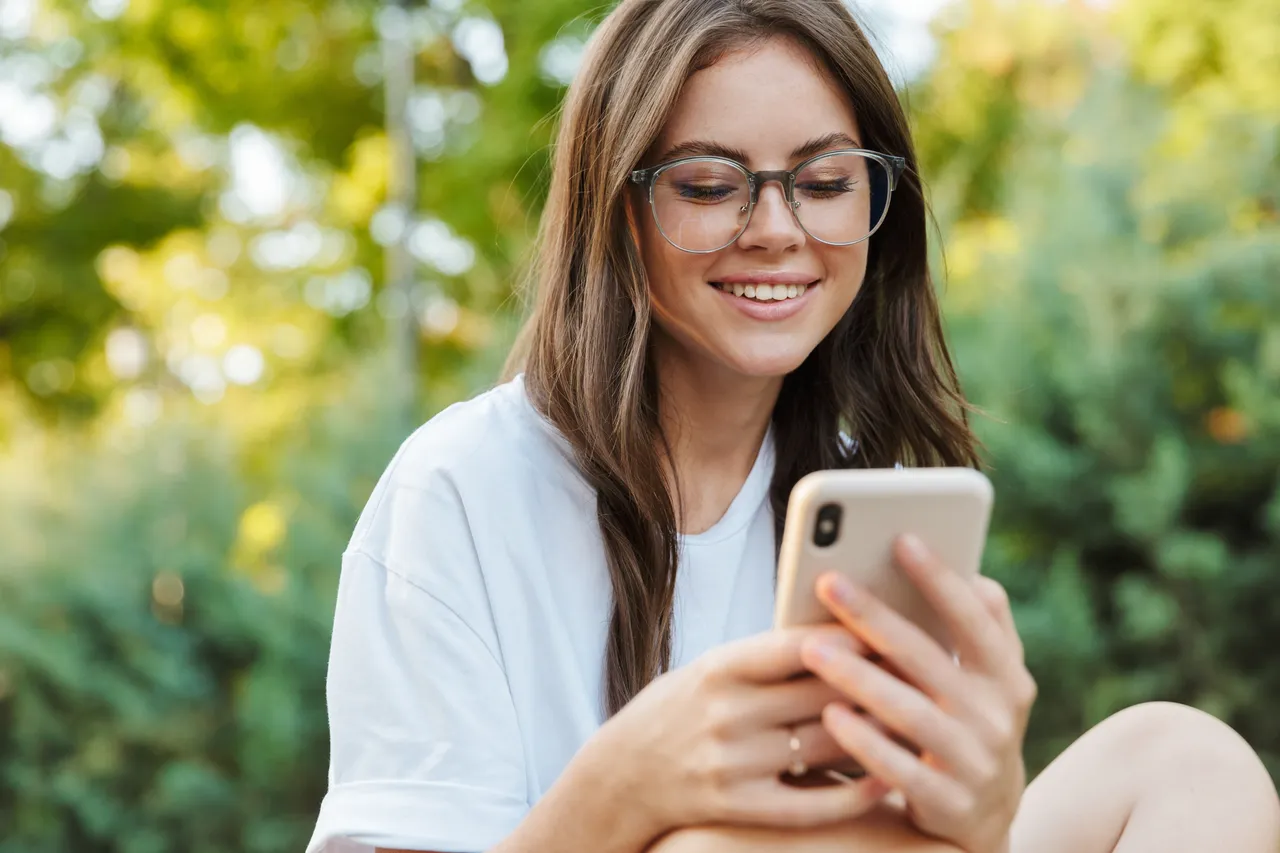 A woman watching videos on her phone