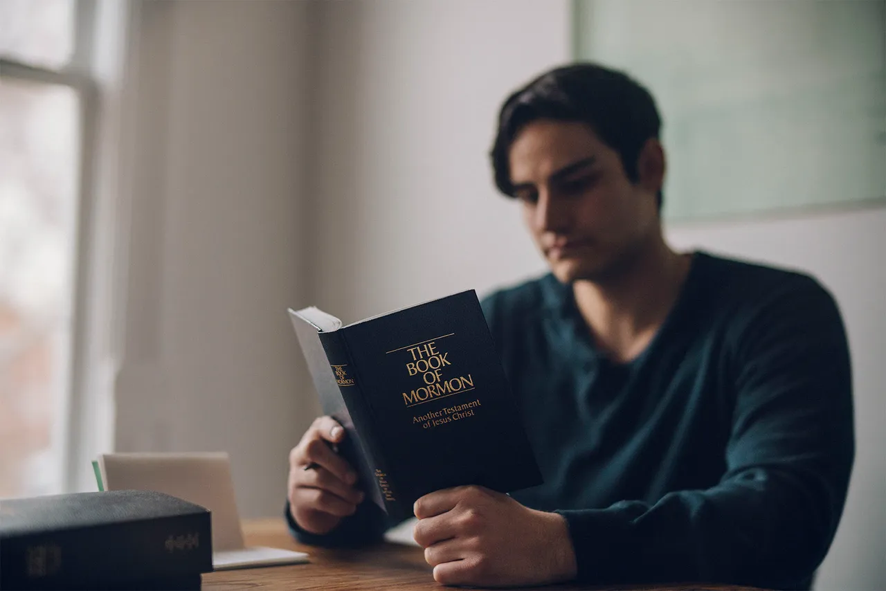 a man reading the Book of Mormon