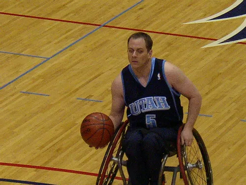 A man (Jason Hokanson) in a wheelchair playing basketball