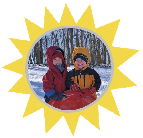 two boys in coats outside