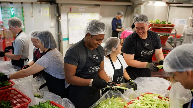 Missionaries helping distribute food during a service project in Hong Kong.