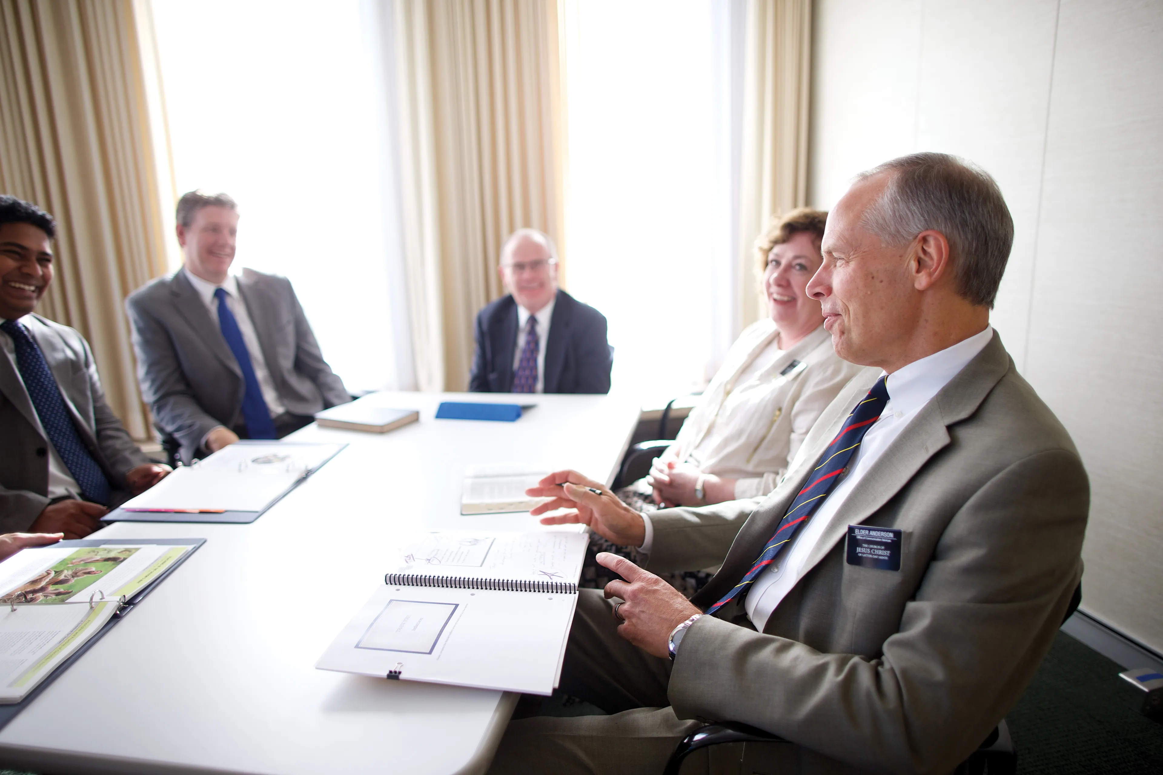 A senior missionary couple participating in a small group meeting.